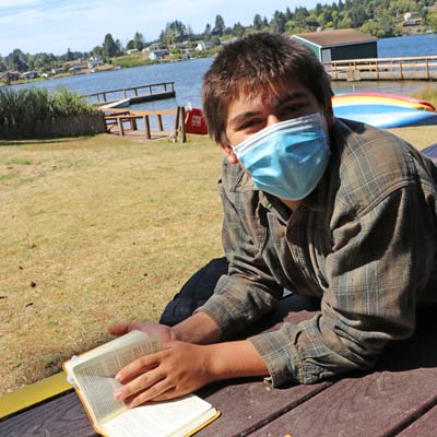 Kid reading at camp